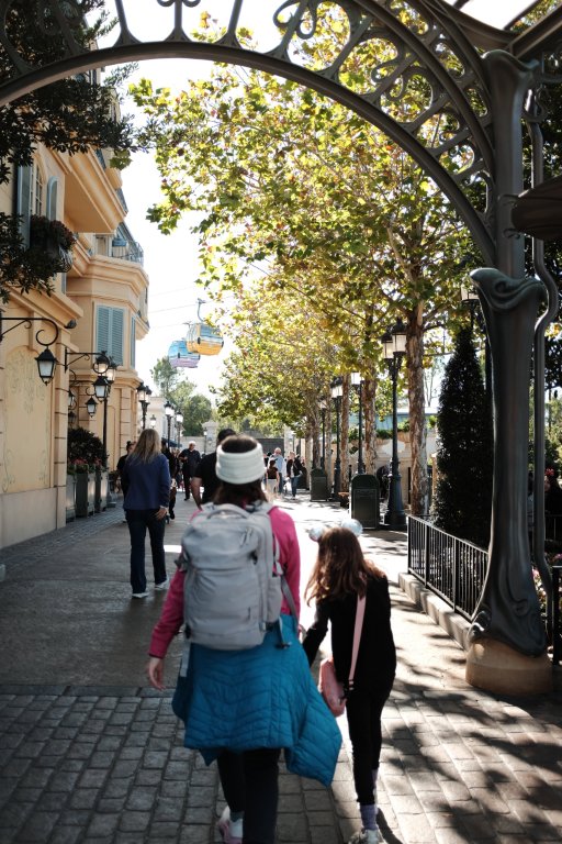 Candid moment of mom and daughter walking through Epcot